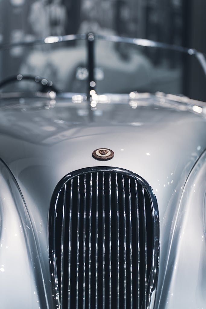Elegant close-up view of a classic retro car grille with a shiny chrome finish.