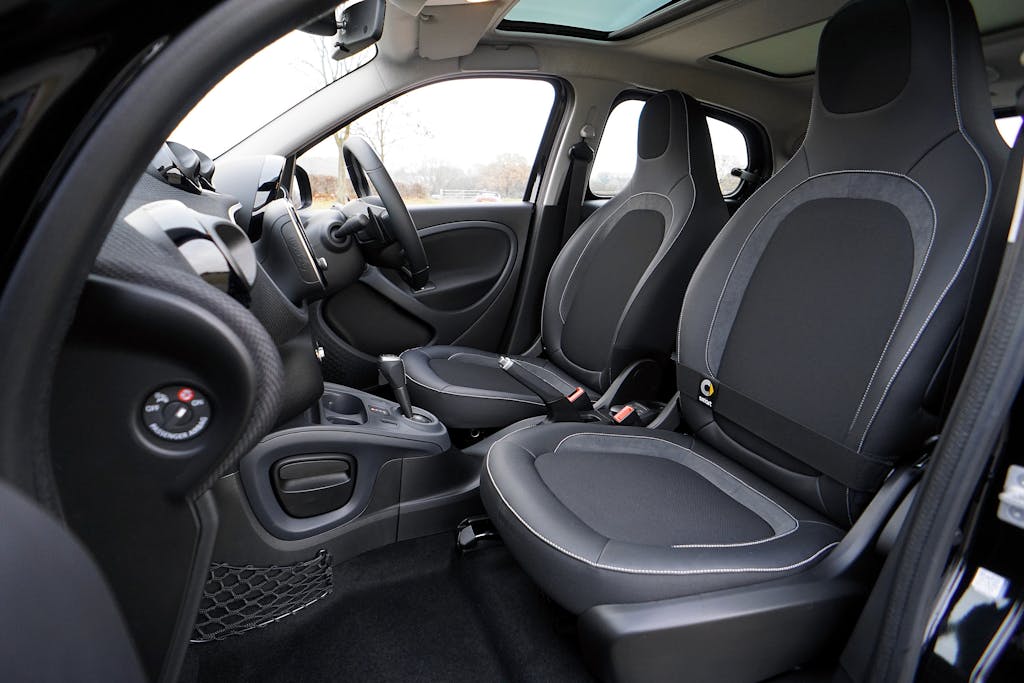 Explore the sleek interior of a modern luxury car featuring leather seats and advanced technology.